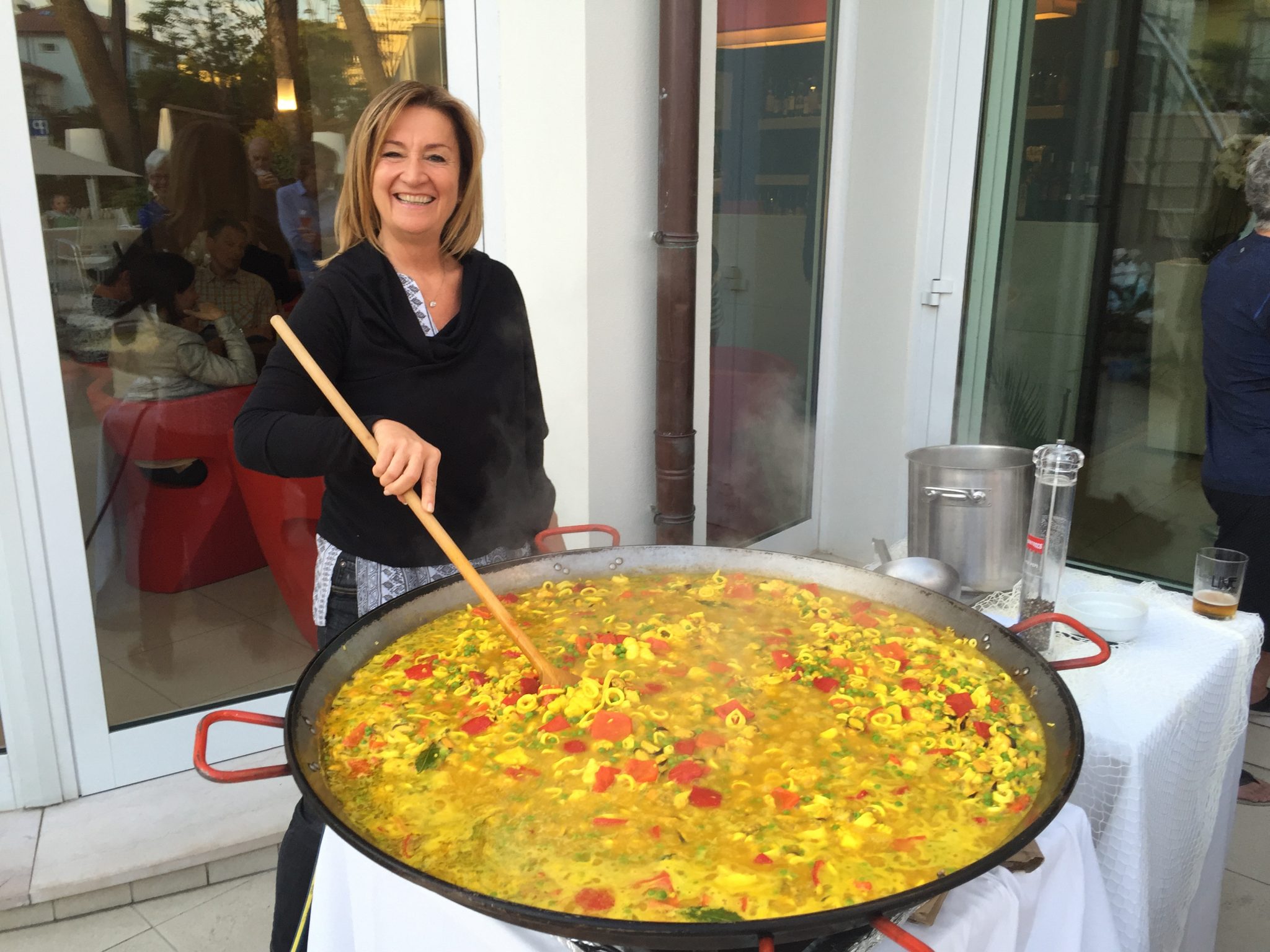 Marina mixes up a giant batch of paella